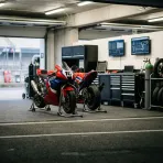 Illustration for our Australian GP practice story: an empty pit garage with motorbikes resting on stands