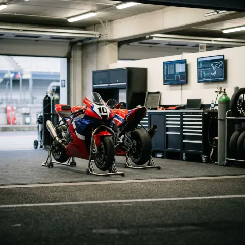 Illustration for our Australian GP practice story: an empty pit garage with motorbikes resting on stands