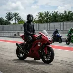 Illustration for our Indonesian GP preview story: a racing motorbike parked on a tropical pit lane apron