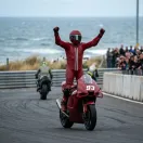Illustration for our Australian Grand Prix Sprint story: a winning rider celebrates crossing the finish line.