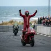Illustration for our Australian Grand Prix Sprint story: a winning rider celebrates crossing the finish line.
